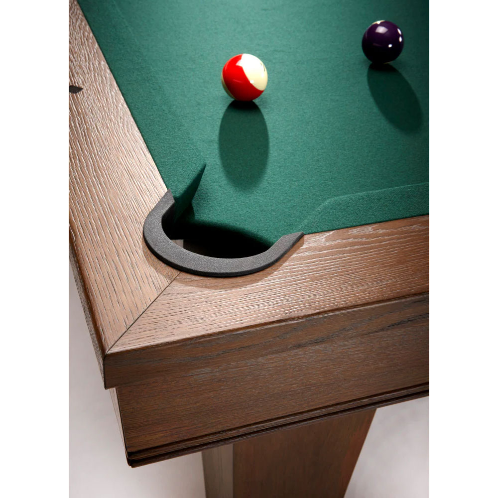 Close-up of an Brunswick Winfield pool table with a nutmeg finish. The playing surface is covered in green felt, and a leather pocket can be seen at the front. Two balls lie on the cloth: one red and white, the other dark purple.