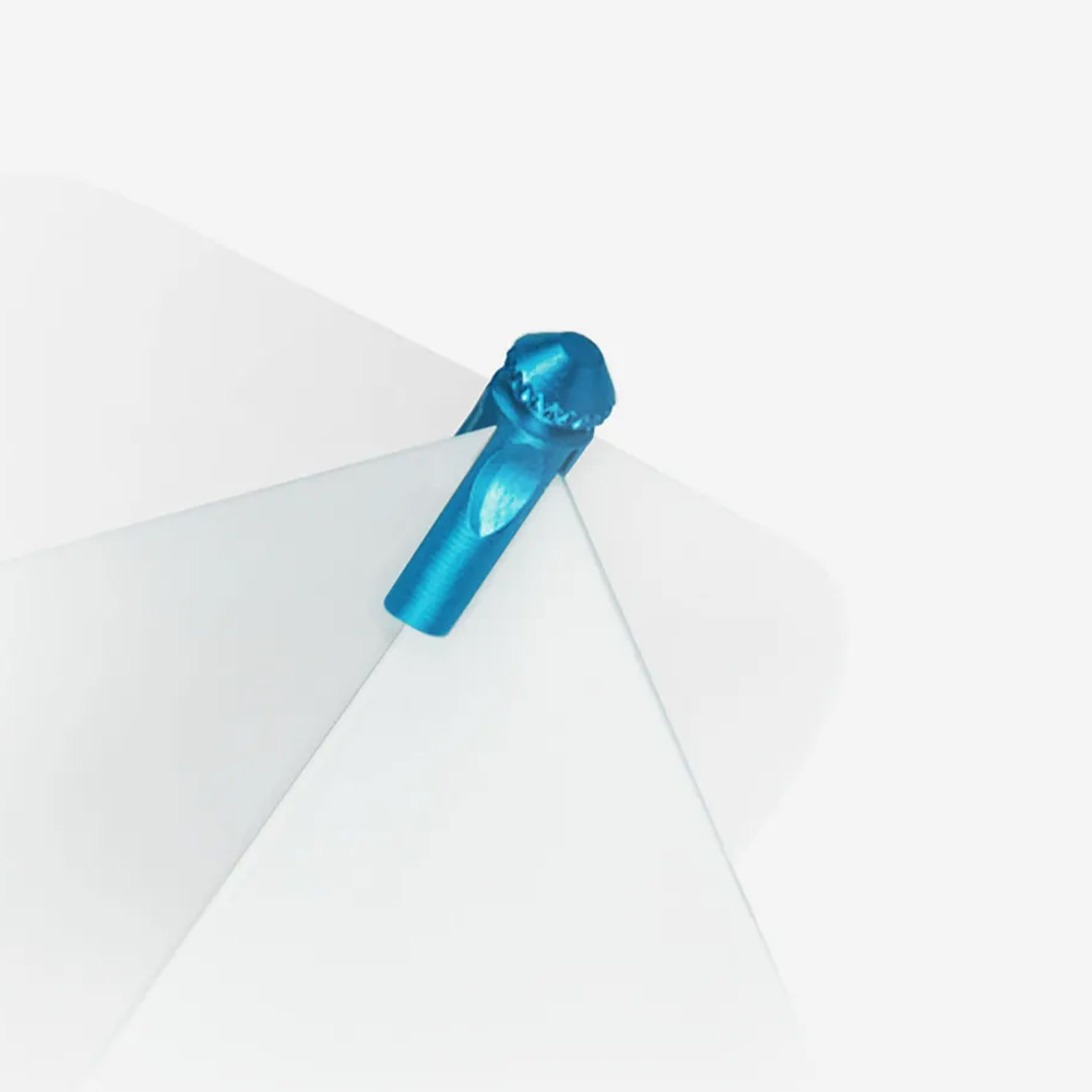Blue Flyprotector from Target, securely attached to a white dart flight. Metal with a ribbed, rounded top, protects the flight from damage caused by subsequent darts. Light turquoise blue.