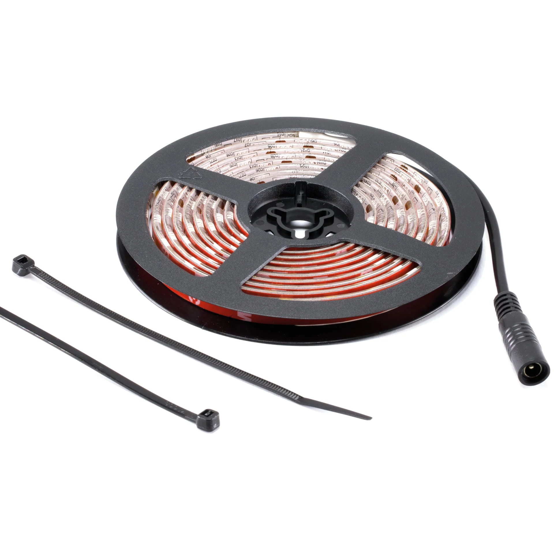 Bande lumineuse LED enroulée sur bobine gris foncé, LED visibles et couche adhésive rouge. Câble d'alimentation noir avec fiche ronde. Deux attaches de câble noires. Bande LED de rechange pour écran plasma.