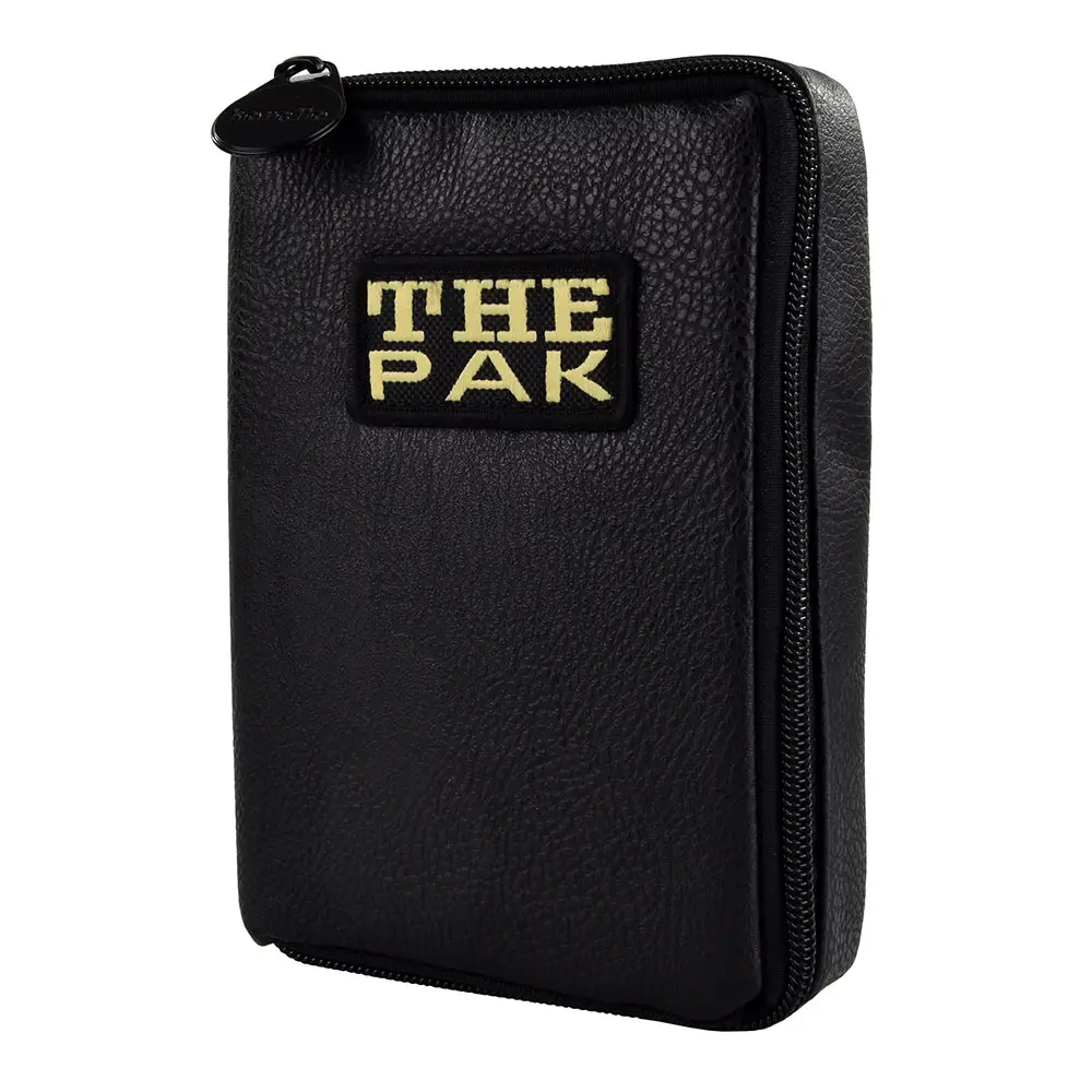 Black ‘The Pak’ dart case, leather edition, made from grained material, standing upright. Zips on the right and top. Black label on the front with gold lettering reading ‘THE PAK’. Compact and handy, protects darts and accessories.