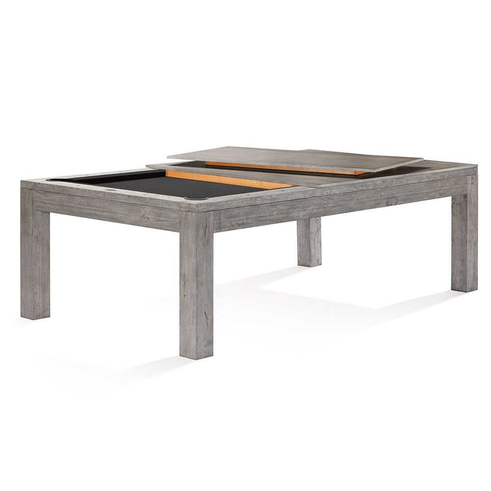 A Sanibel pool table by Brunswick in Rustic Grey, partially covered as a dining table. Left: black playing surface with pockets. Right: two grey cover panels placed diagonally on top of each other, showing conversion.