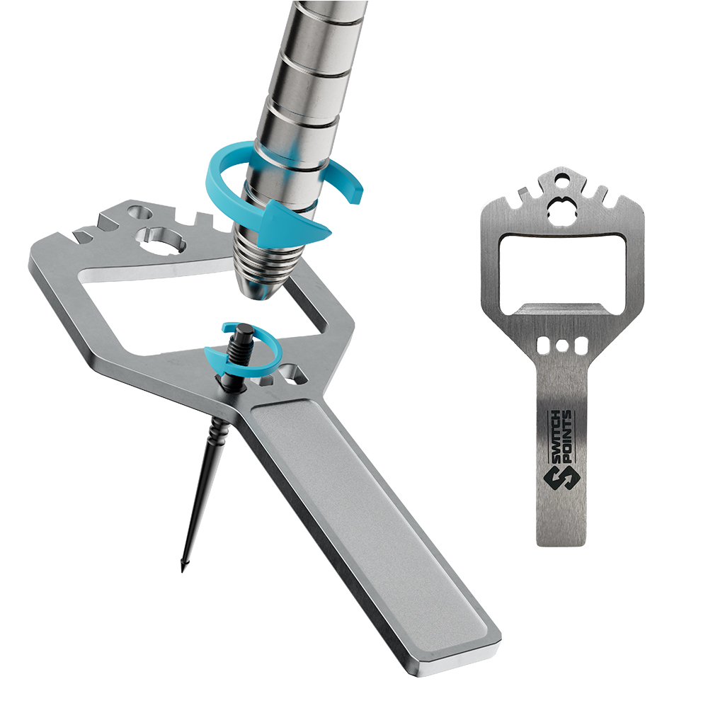 Versatile silver key-shaped tool for driving in a dart tip and small screws, featuring blue arrows to indicate the turning motion. Includes a bottle opener and hexagonal cut-outs. On the right-hand side, it lies flat with the ‘SWITCH POINTS’ logo.